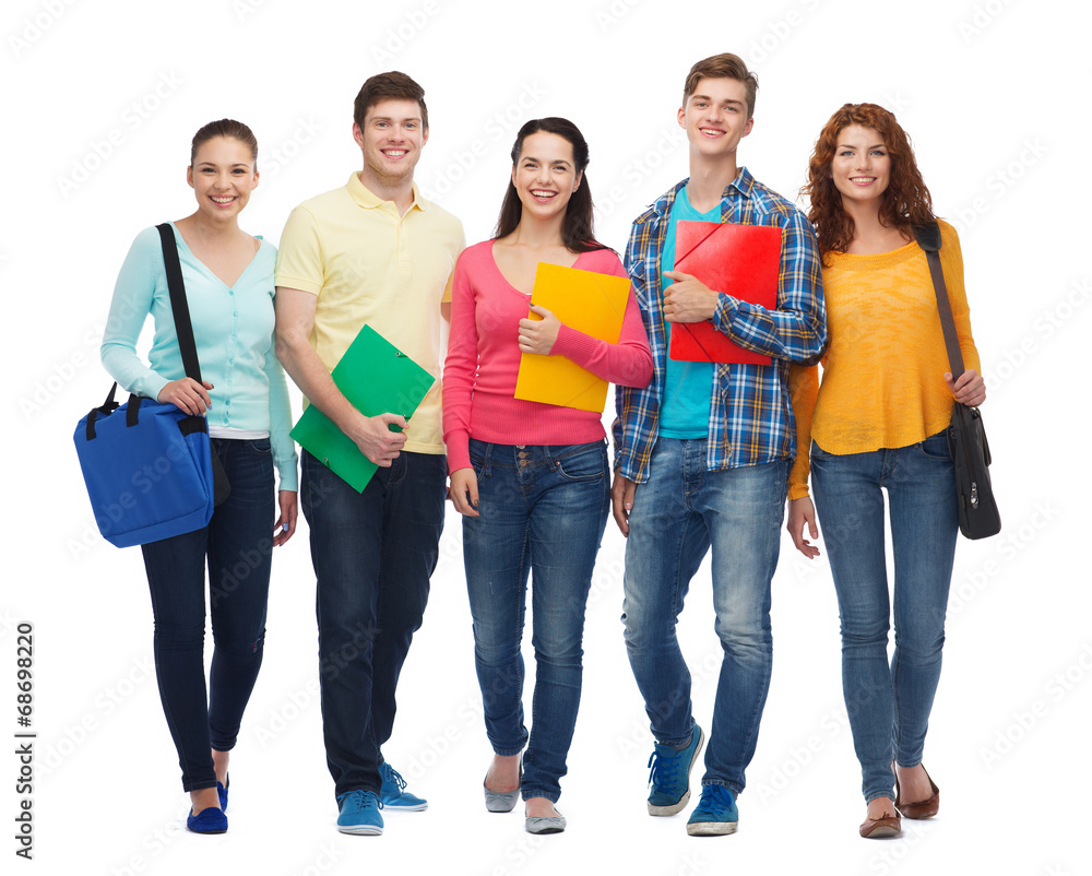 group of smiling teenagers with folders and bags