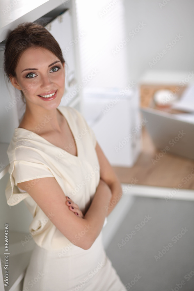 Close-up portrait of a smiling business woman standing in her Close-up portrait of a smiling business woman standing in her