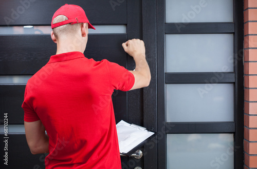 Delivery man knocking on the client's door