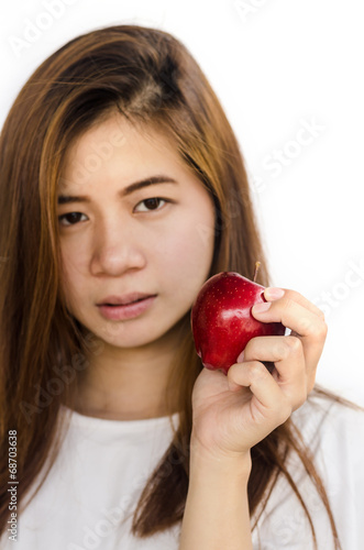 young woman showing an apple.