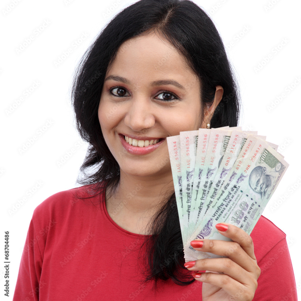 Woman holding Indian currency notes against white background Woman holding Indian currency notes against white background