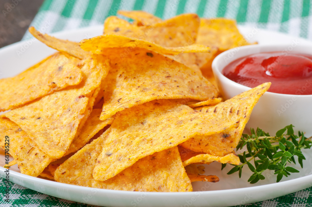 Nachos and tomato dip decorated with thyme leaves Nachos and tomato dip decorated with thyme leaves