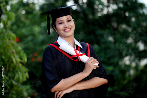 Young female student with diploma at outdoors