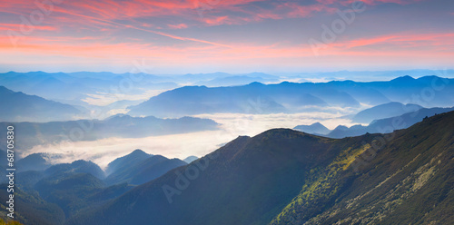 Fototapeta Naklejka Na Ścianę i Meble -  Foggy summer panorama of the mountains.