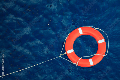 Lifebuoy in a stormy blue sea, safety equipment in boat