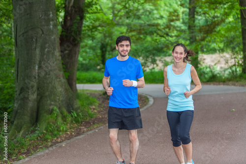 Young sportive couple jogging at the park
