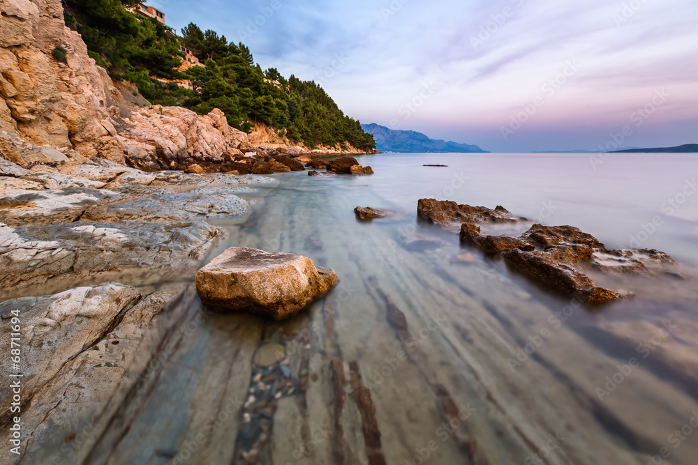Rocky Beach and Transparent Adriatic Sea near Omis in the Evenin