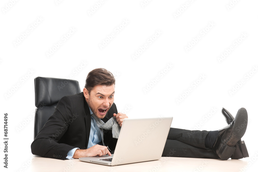 Angry businessman working at his laptop computer. Angry businessman working at his laptop computer.