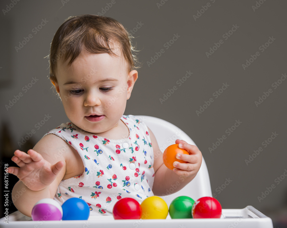 cute baby girl playing with colorful balls cute baby girl playing with colorful balls