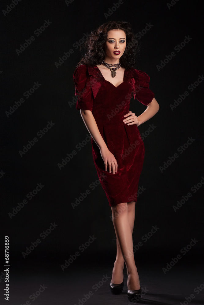 Fashion studio shot of beautiful woman wearing evening dress Fashion studio shot of beautiful woman wearing evening dress