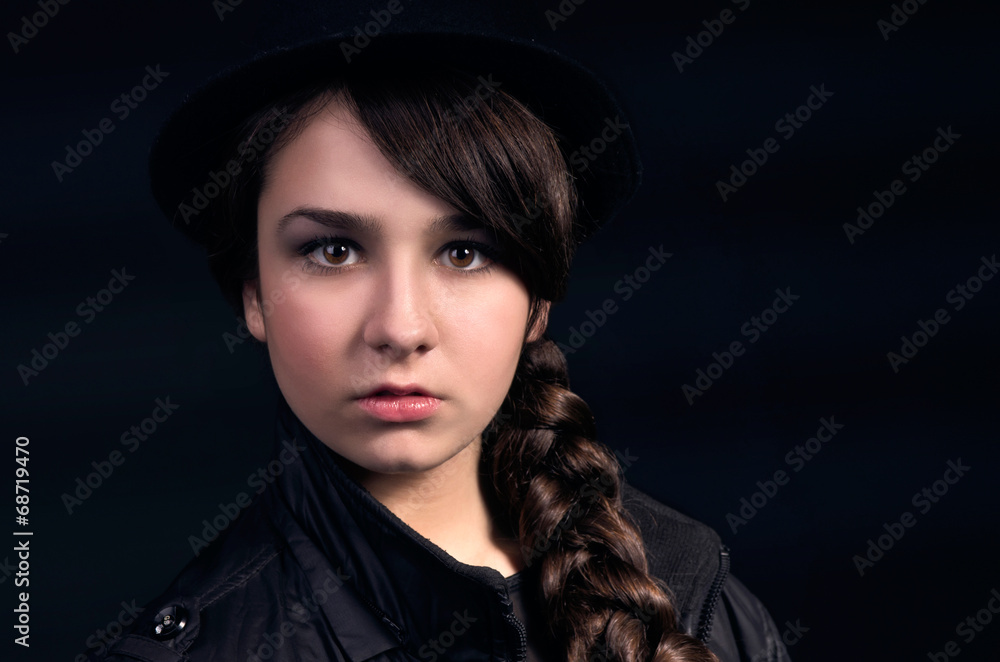 Portrait of a beautiful girl with a plait and wearing a hat Portrait of a beautiful girl with a plait and wearing a hat