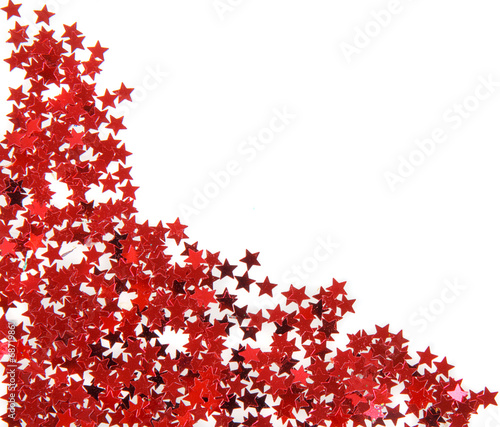 Red stars in the form of confetti on white