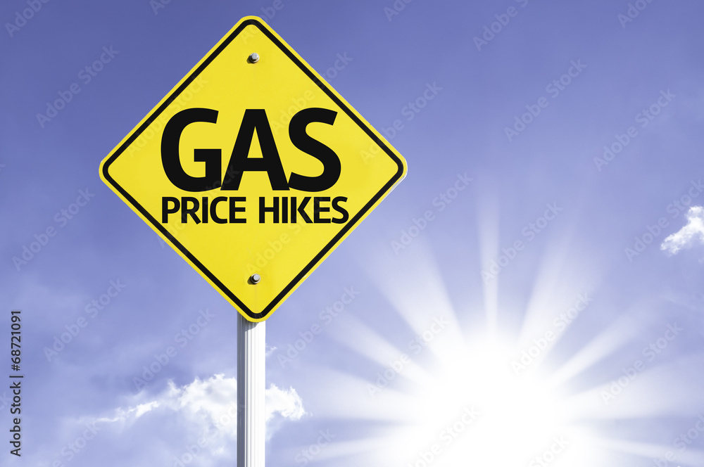 Gas Price Hikes road sign with sun background Gas Price Hikes road sign with sun background
