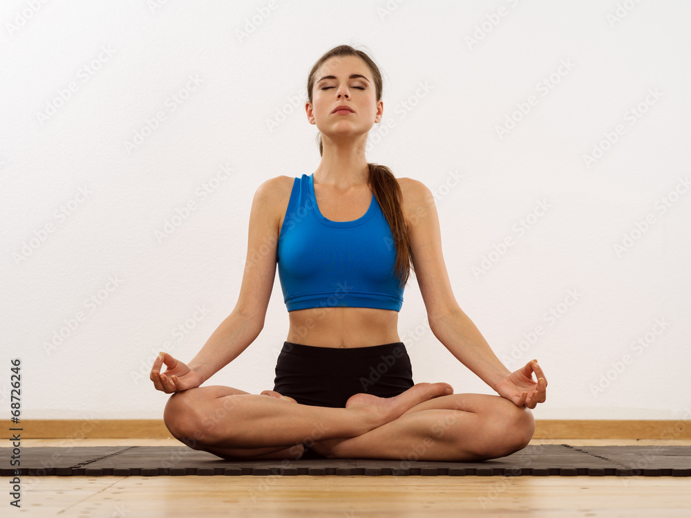 Young woman doing yoga lotus position Young woman doing yoga lotus position