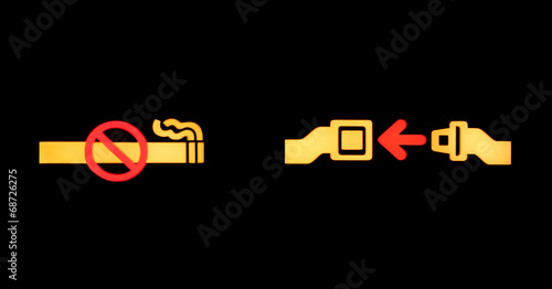 Airplane seatbelt sign and non smoking sign isolated on black