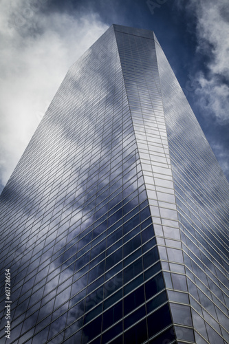 enterprise, skyscraper with glass facade and clouds reflected in