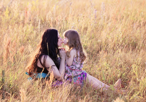 Mother and daughter in meadow