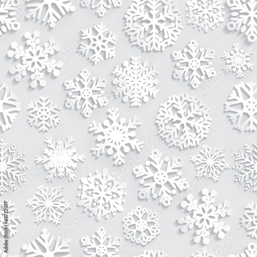 Seamless pattern of paper snowflakes on gray