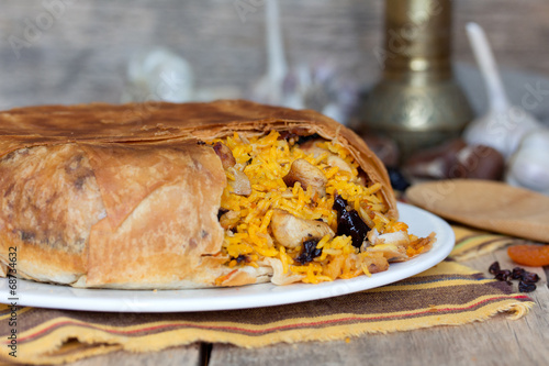 Pilaf in tortillas with dried fruits, garlic and burberry