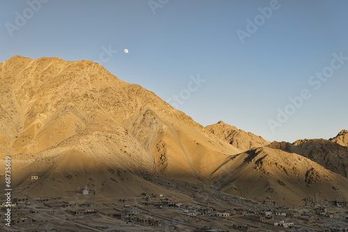 Ancient village in mountains under the moon