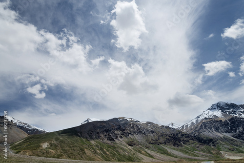 Snowcapped mountains under deep blue sky and beautiful clouds