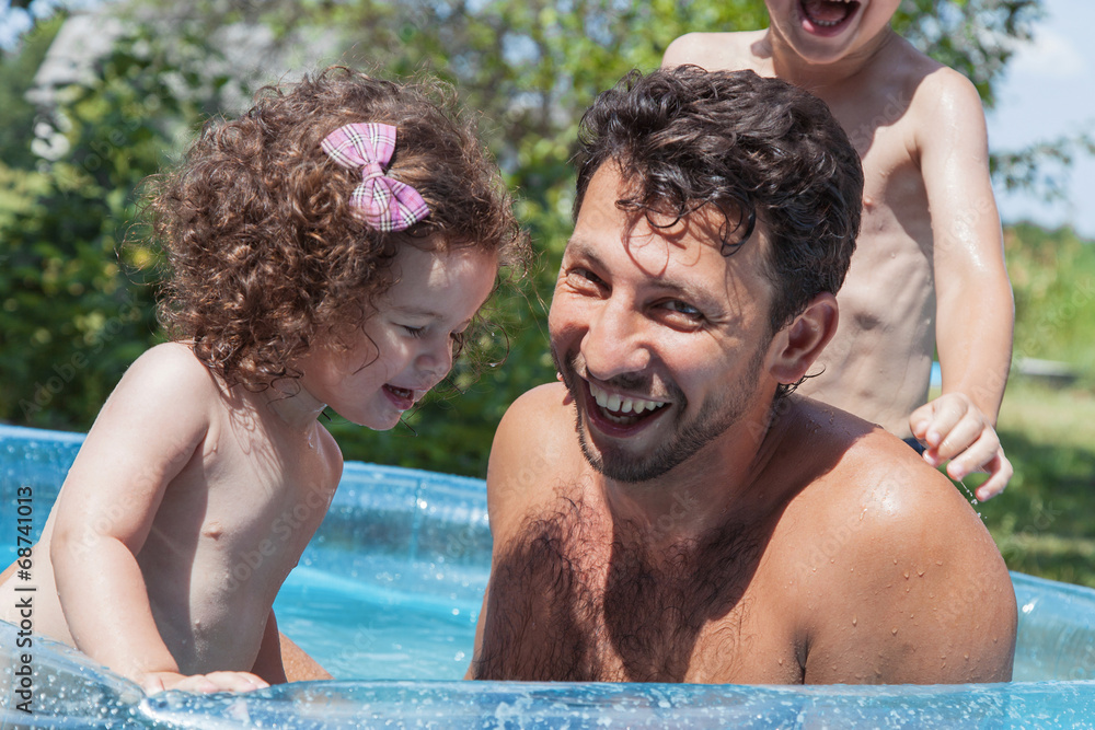 Father with children in pool
