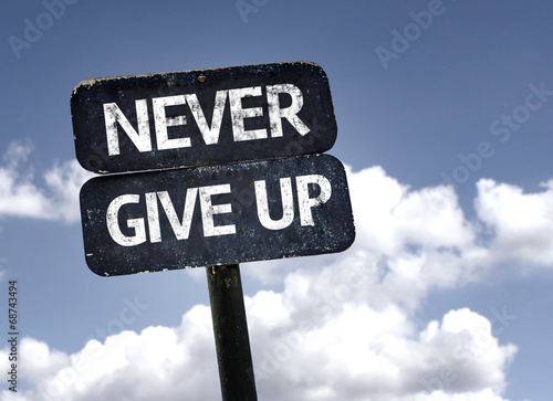 Never Give Up sign with clouds and sky background