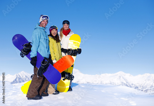 Three Snowboarders on Top of the Mountain