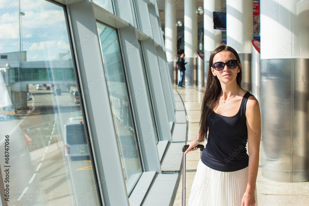 Young beautiful woman in airport while waiting for flight Young beautiful woman in airport while waiting for flight