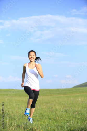 Runner athlete running on sunrise grass seaside