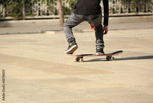 young boy skateboarding in the city 