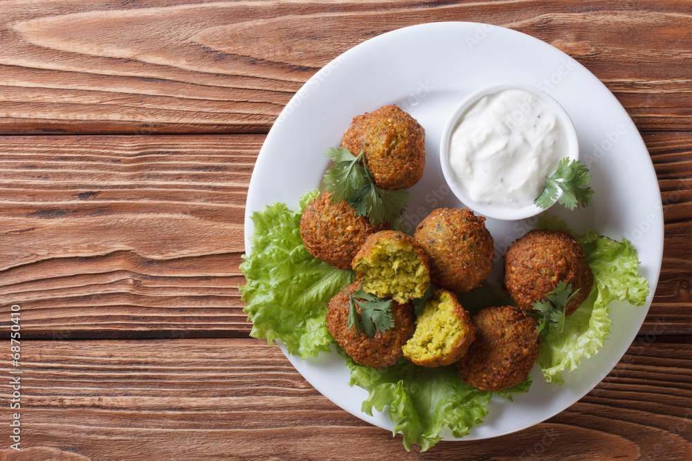 delicious falafel on lettuce with tzatziki top view delicious falafel on lettuce with tzatziki top view