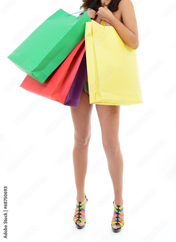 Beautiful young naked woman holding shopping bags, over white ba