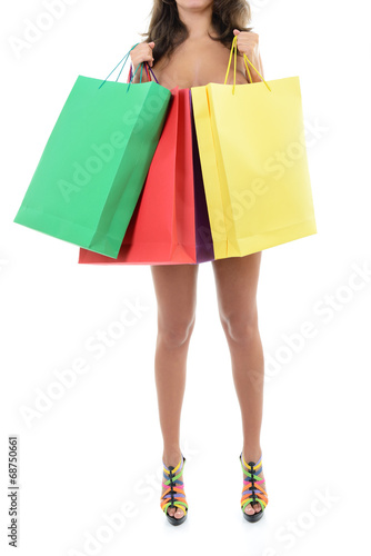 Beautiful young naked woman holding shopping bags, over white ba