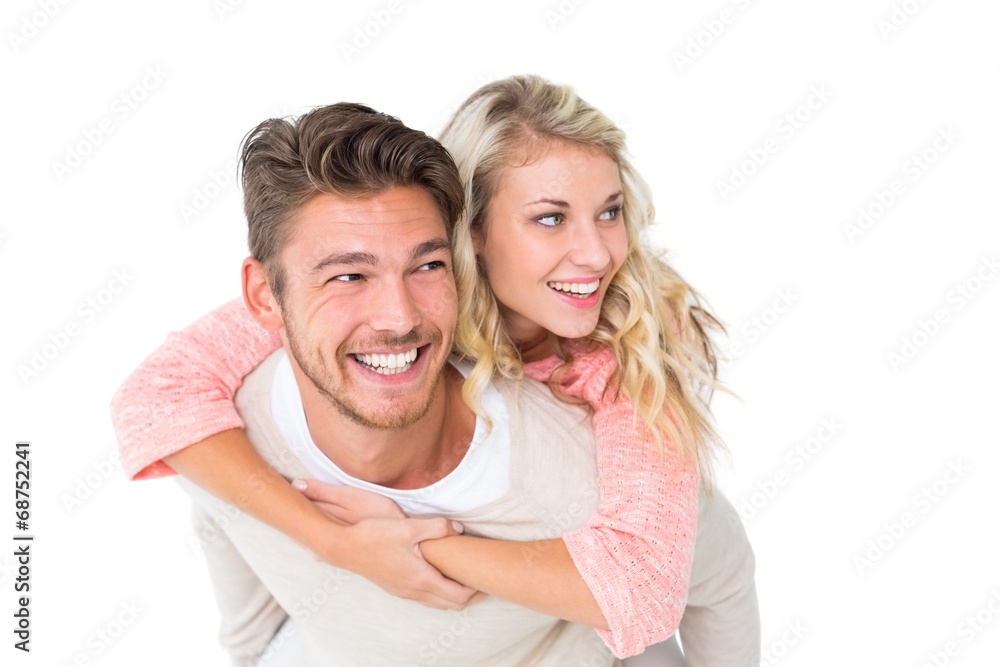 Handsome man giving piggy back to his girlfriend Handsome man giving piggy back to his girlfriend