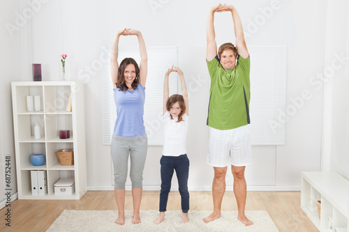 Portrait Of Fit Family Performing Yoga