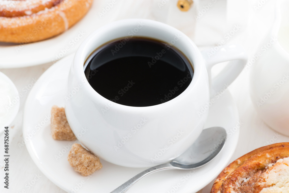 cup of black coffee and sweet bun for breakfast, close-up cup of black coffee and sweet bun for breakfast, close-up