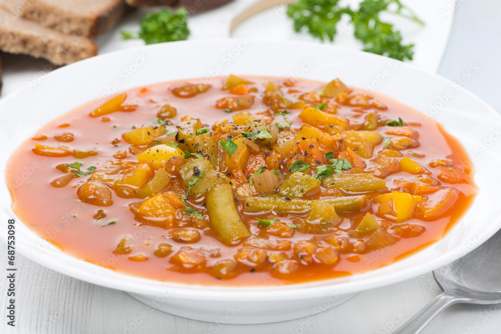 tomato soup with green lentils and vegetables, close-up