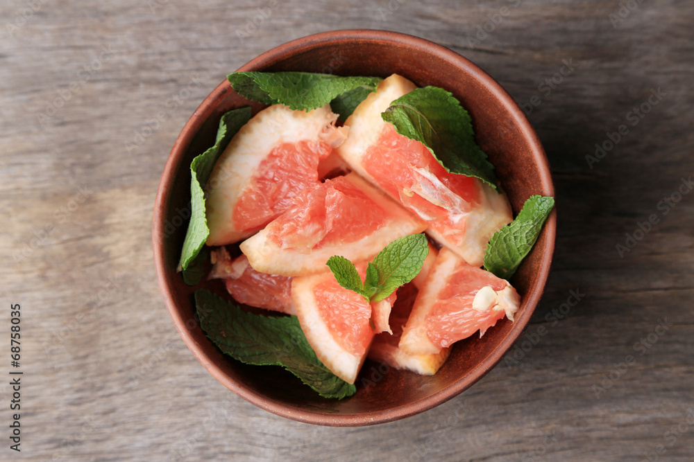Ripe chopped grapefruit with mint leaves Ripe chopped grapefruit with mint leaves