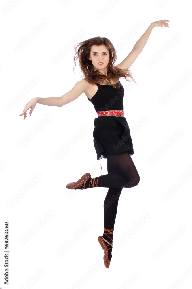 Beautiful folk dancer jumping on white background