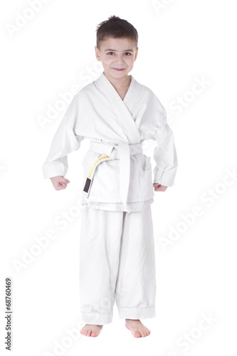 A young boy fighter in white kimono isolated on white background