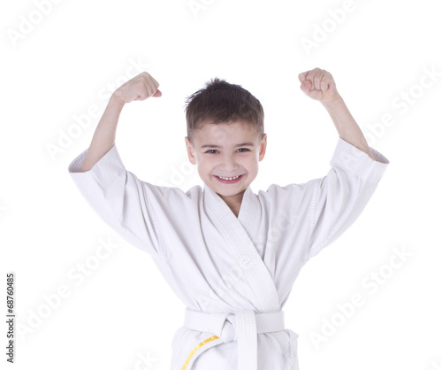 Young boy fighter in kimono with hand up isolated on white backg