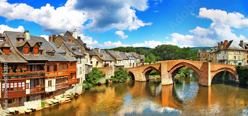 Canvas Print France Espalion medieval river view with arched stone bridge 8K, old houses and wooden balconies reflection no people, Aveyron