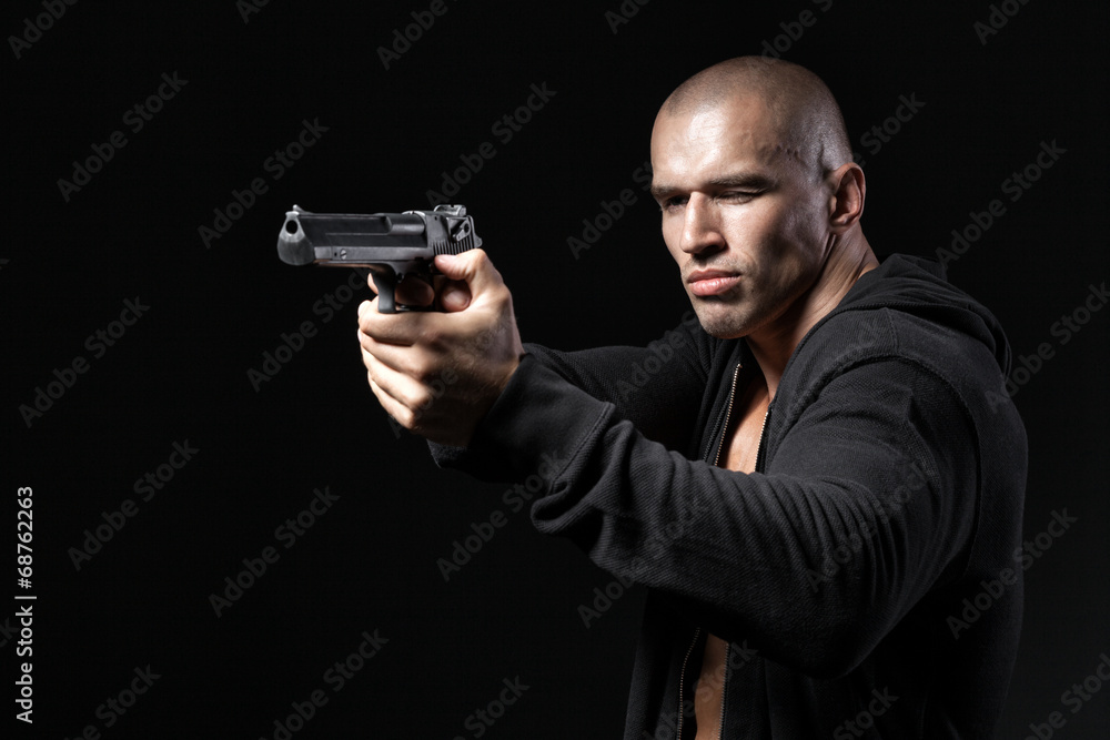 man shooting gun isolated on black background man shooting gun isolated on black background
