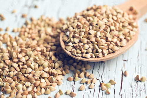 Slika na platnu uncooked buckwheat on wooden spoon