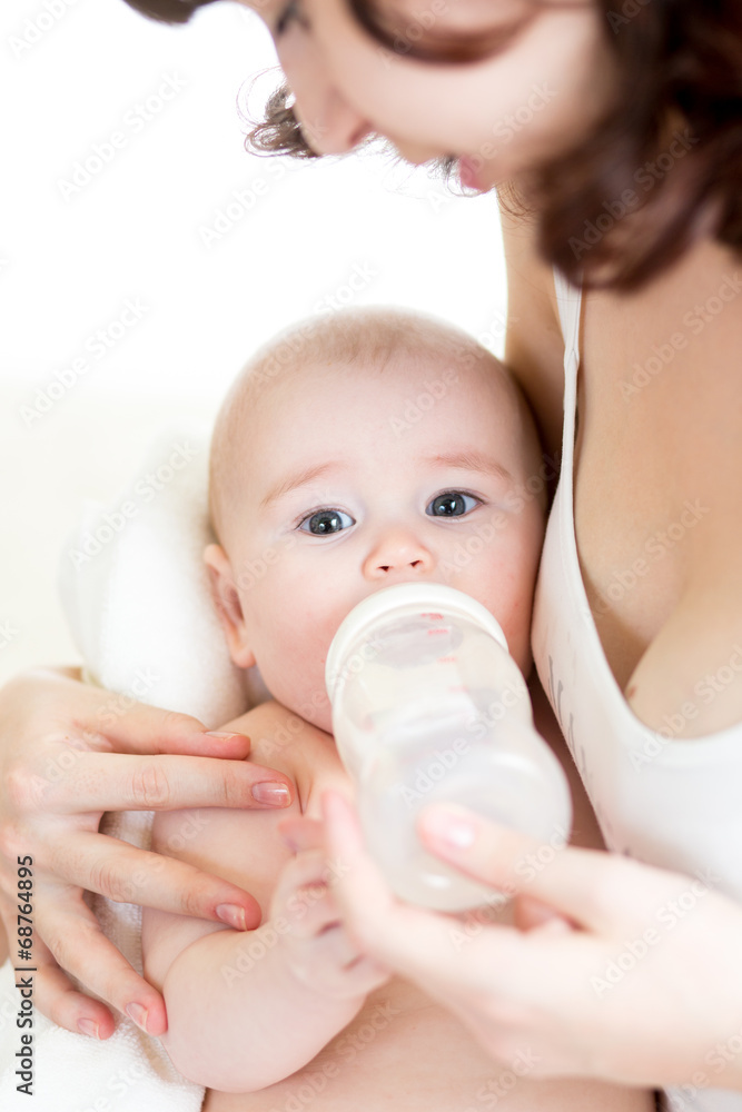 mom feeding by milk her baby infant from bottle mom feeding by milk her baby infant from bottle