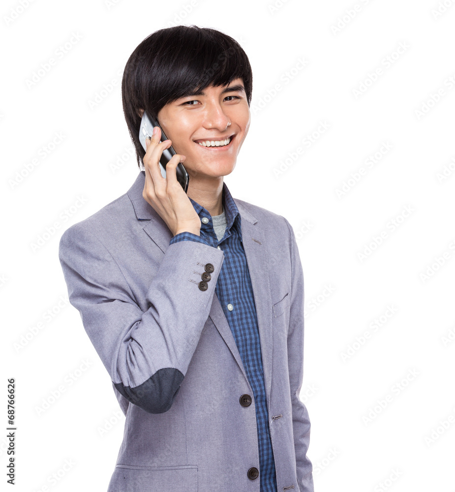 Asian young businessman talk to mobile phone Asian young businessman talk to mobile phone