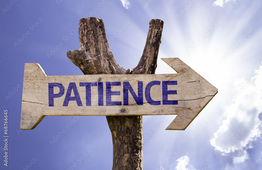 Patience wooden sign with a sky background
