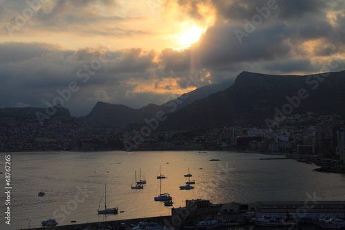 cloudy sunset with contrast setting the sun in Calpe