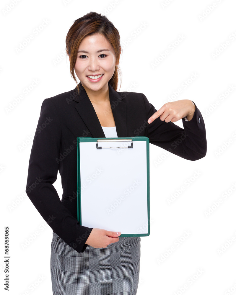 Businesswoman hold clipboard with with finger point to blank pap Businesswoman hold clipboard with with finger point to blank pap